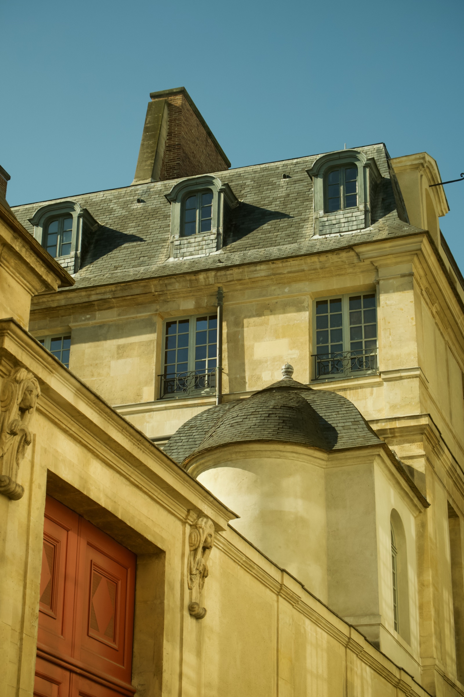 Stone facade with dormers and a domed turret