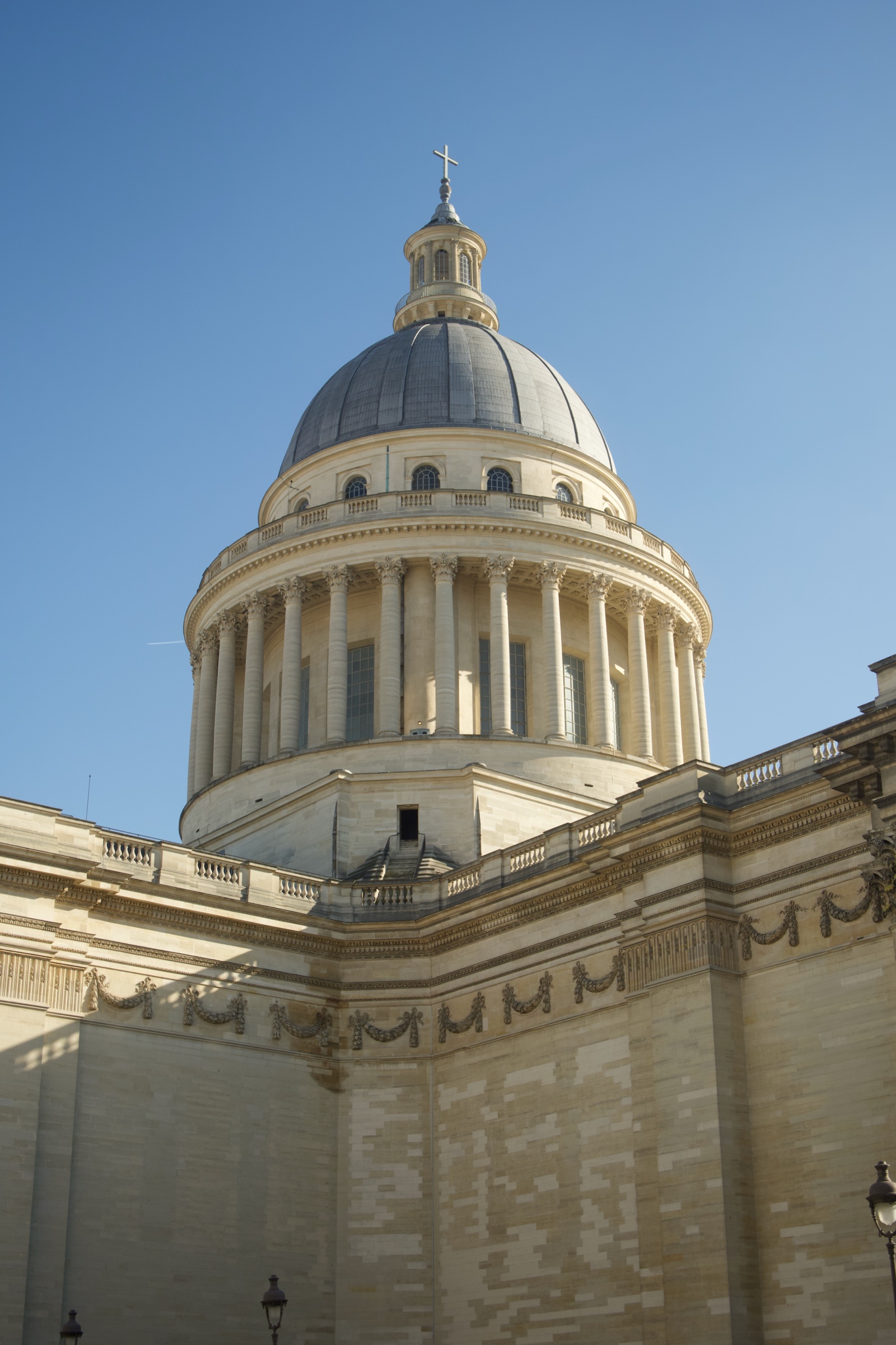 The Panthéon dome rising over its wall against a clear sky